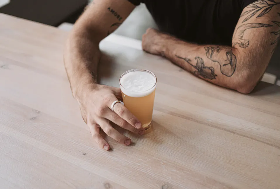 man holding a craft beer